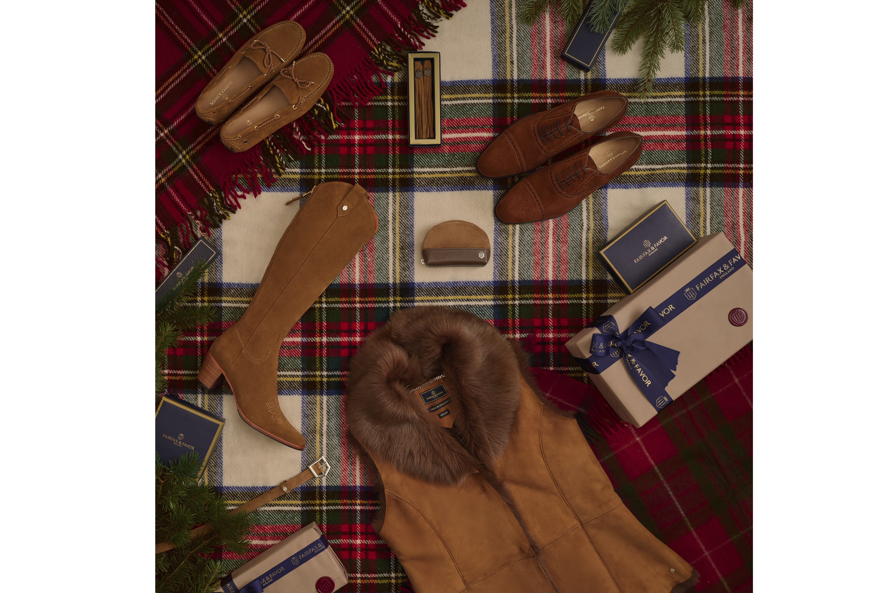 Flat lay photo shoot with shoes handbags and Christmas presents laying down on a tartan rug